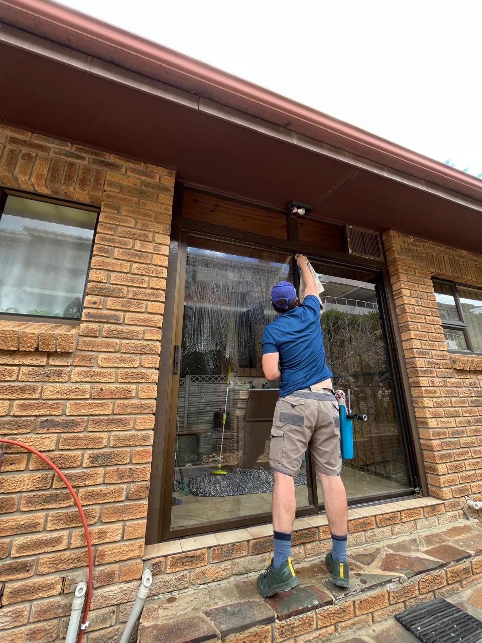 Window cleaner using a water-fed pole on a Somerset West home